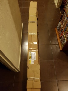 Long, think box delivered by a courier