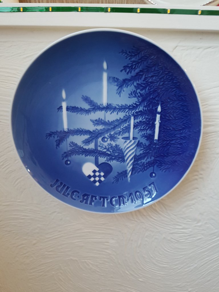Blue plate featuring Christmas tree branch, decorations and candles