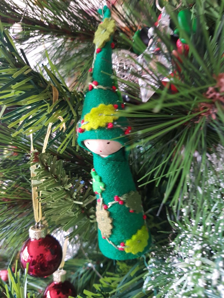 Small hanging ornament - bright green pixie with leaves stitched to her bright green outfit; wooden face