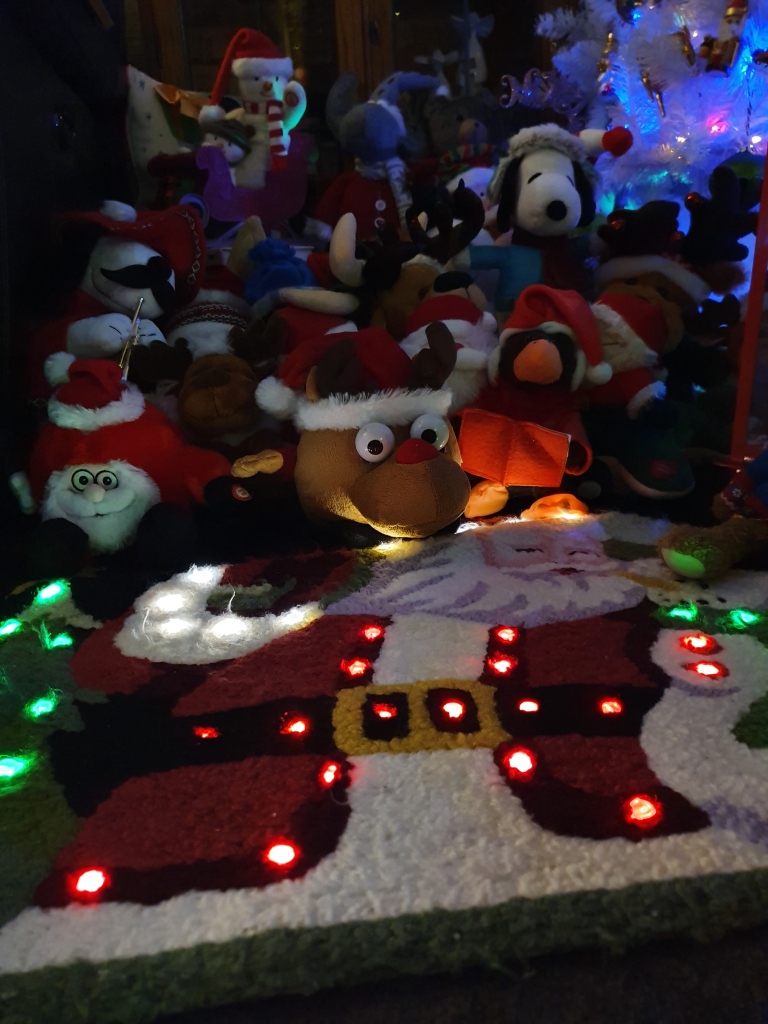 Christmas mat that lights up with toys behind it